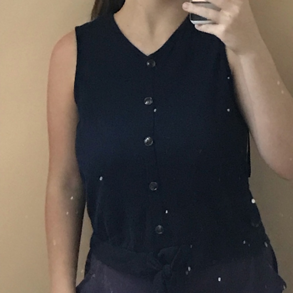 Baby shirt with brown buttons and white lace in the back.